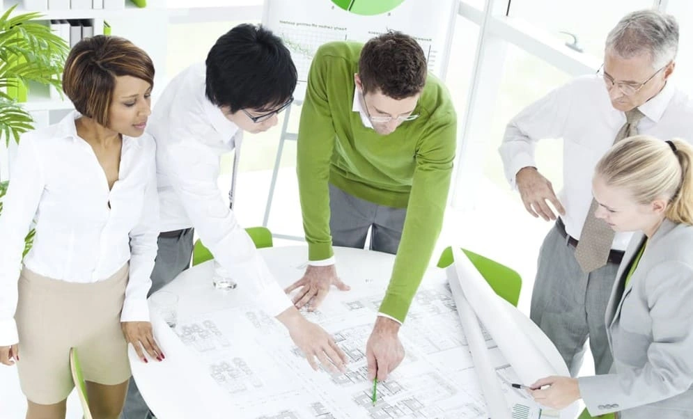 Eco-friendly architectural team using sustainable printing for blueprints