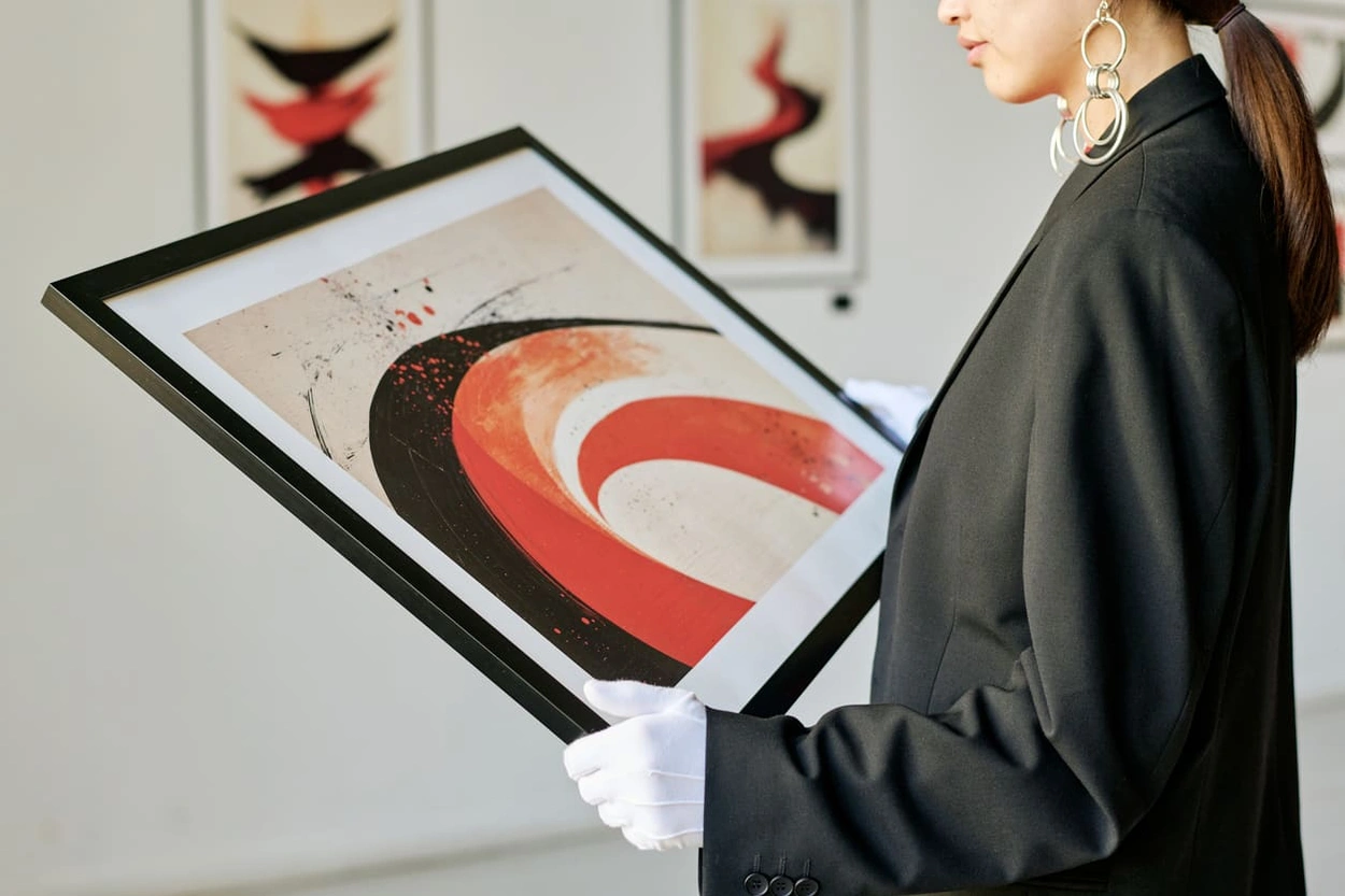 Curator assessing art prints made with the best printer for artists