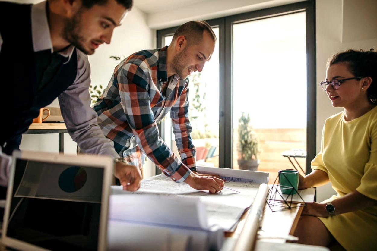 Coworkers discussing a new blueprint annotation guide