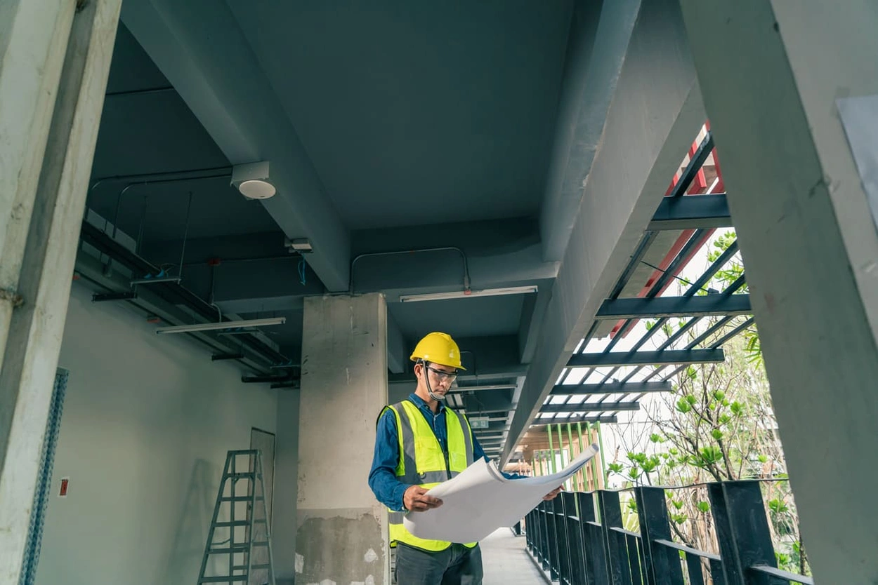 Construction foreman reading blueprints made from a BIM printer