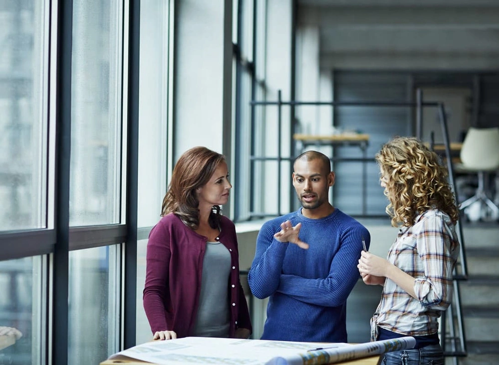 Coworkers discussing what CAD plotter paper to continue using for projects