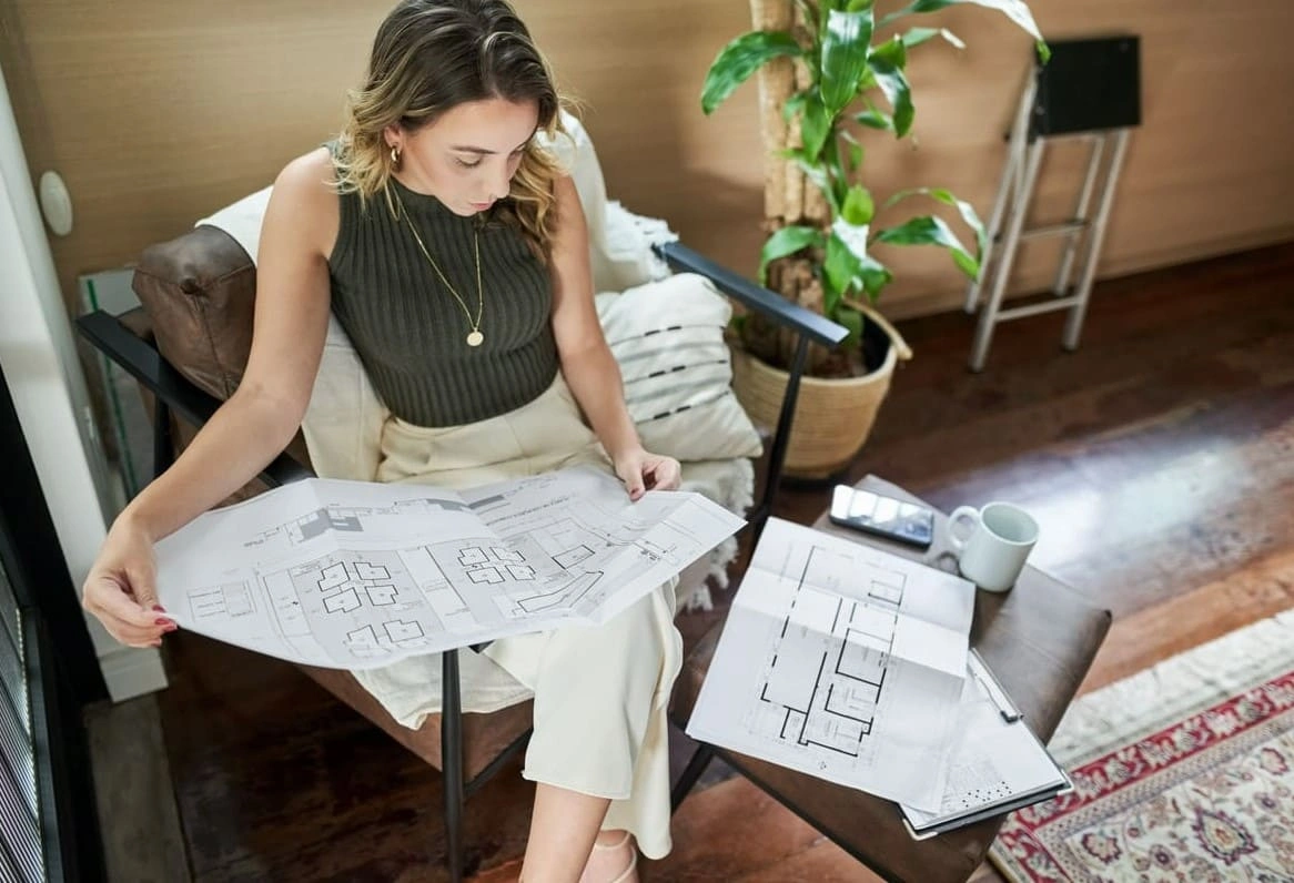 Architect assessing landscape and urban planning progress in an office