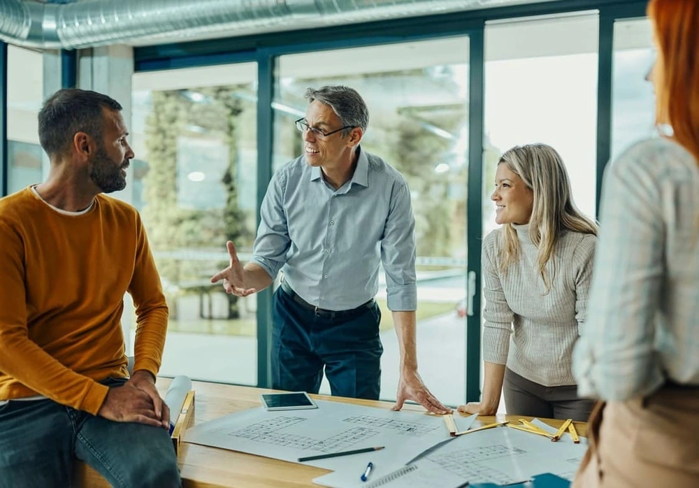 AEC team reviewing plans made with eco-friendly printing tools AEC team reviewing plans made with eco-friendly printing tools