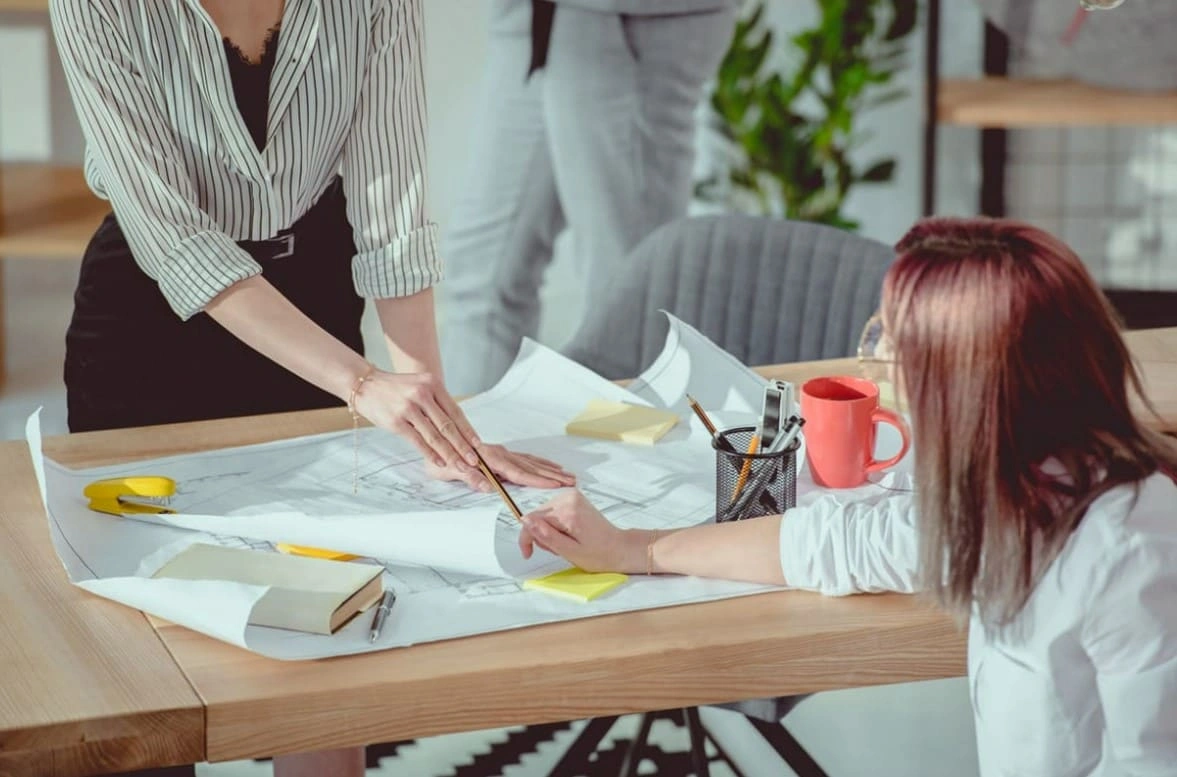 Team quickly reviewing printouts once the company streamlined business operations by purchasing in in-house printer