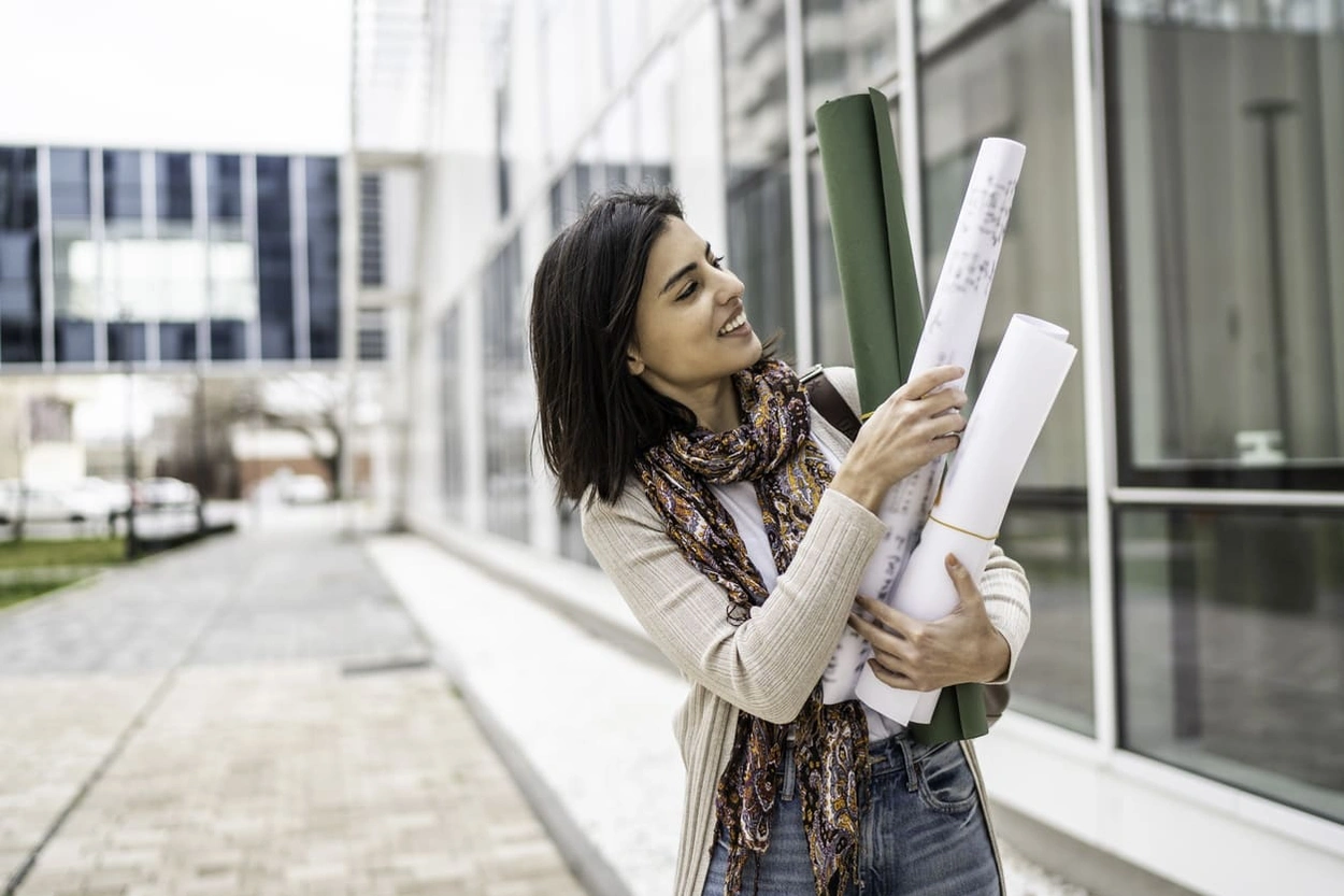 Architect carrying architecture landscape plan documents to an office