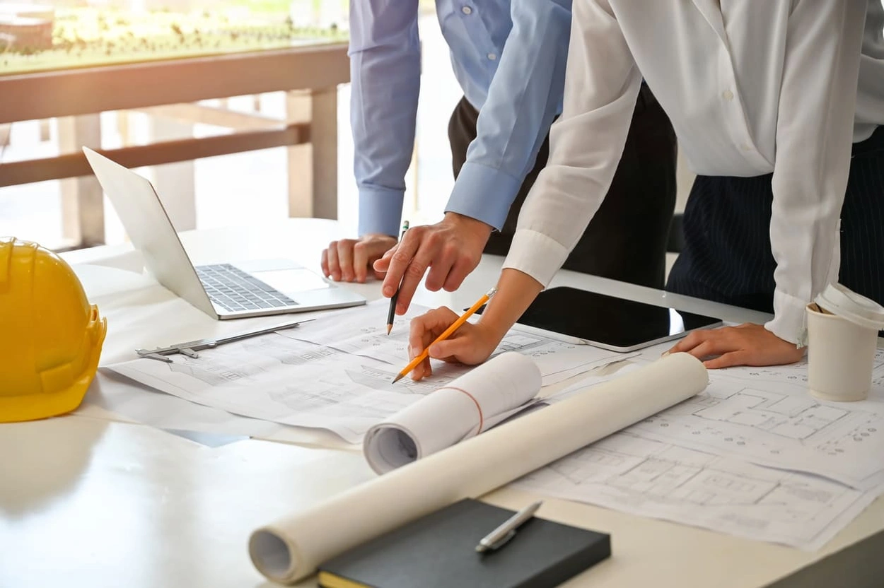 Coworkers creating a detailed process for preparing files for large format printing Coworkers creating a detailed process for preparing files for large format printing