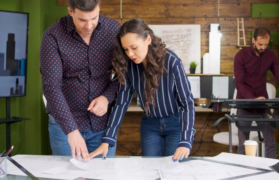 Architects quickly revising designs with access to a CAD plotter Architects quickly revising designs with access to a CAD plotter