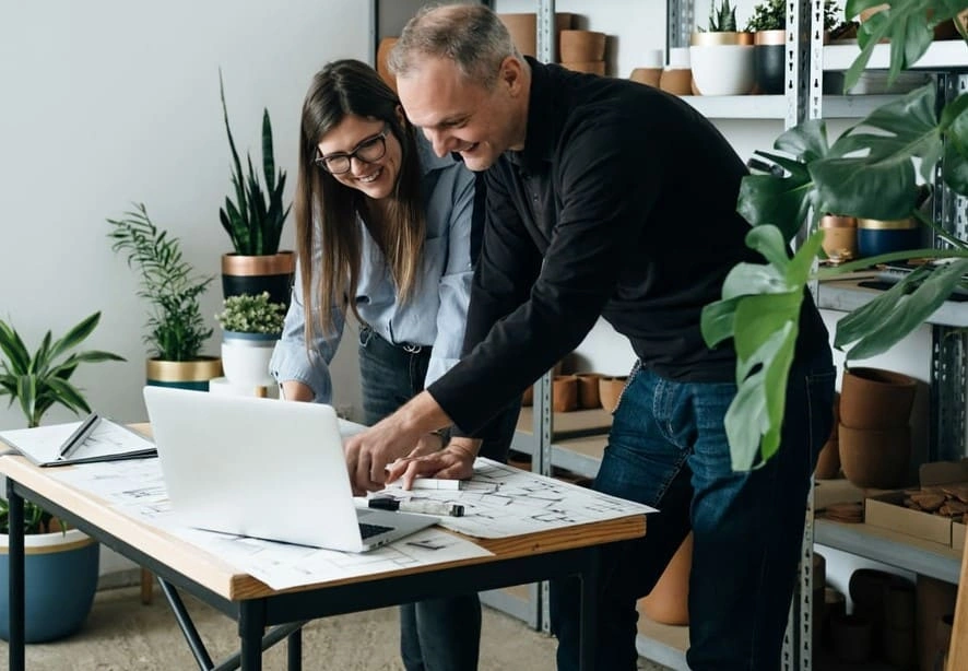 Coworkers look at printer settings to reduce plotter waste