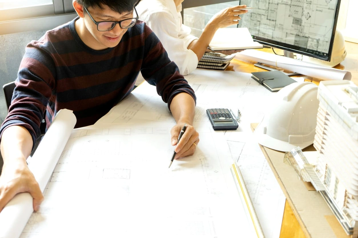 AEC professional reviewing blueprints printed in-house and made with BM construction software