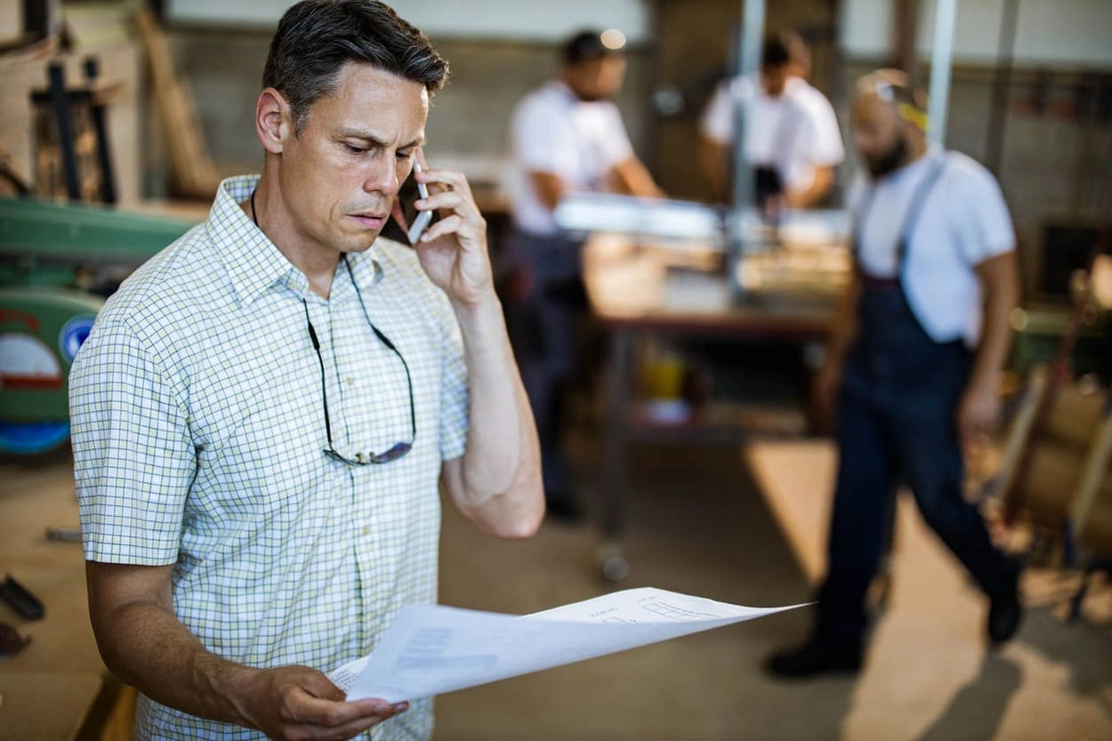 AEC project manager analyzing blueprints with common large format printing errors