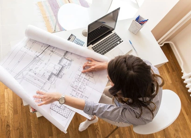 Architect reviewing detailed prints from a new printer for architects