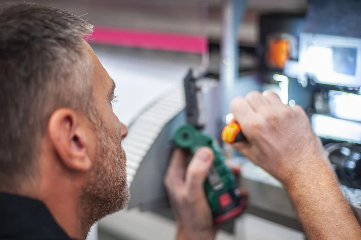 Professional repairing a large format printer under the terms of a printer warranty Professional repairing a large format printer under the terms of a printer warranty