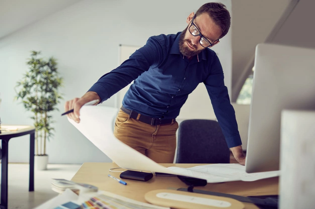 Architect looking at high-quality printouts after buying the right printer Architect looking at high-quality printouts after buying the right printer