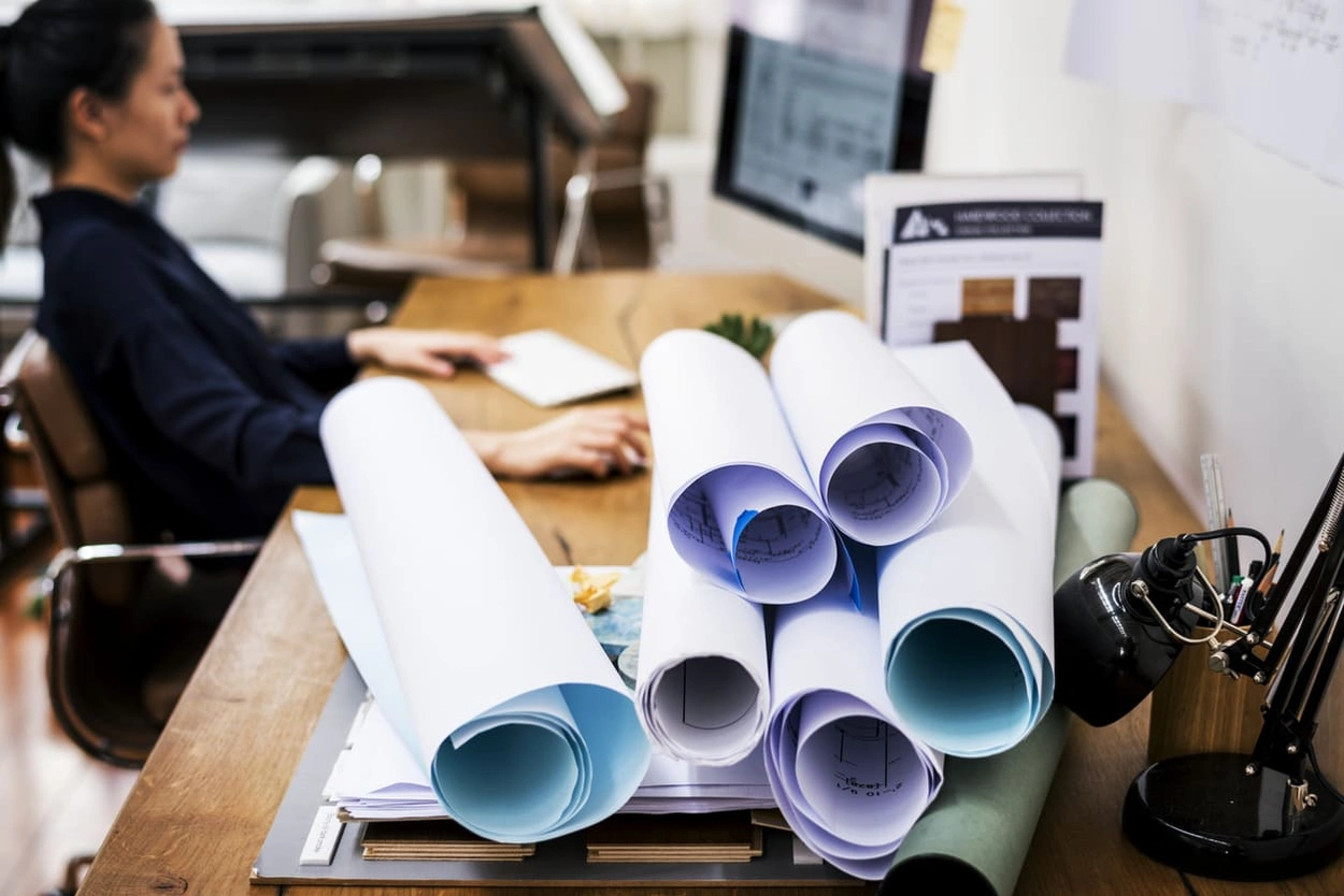 AEC professional at her computer after printing oversized plans