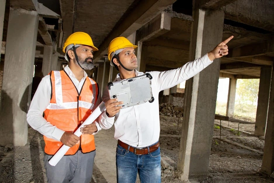 Construction managers using blueprints and tablets simultaneously due to better wide format scanning workflows Construction managers using blueprints and tablets simultaneously due to better wide format scanning workflows