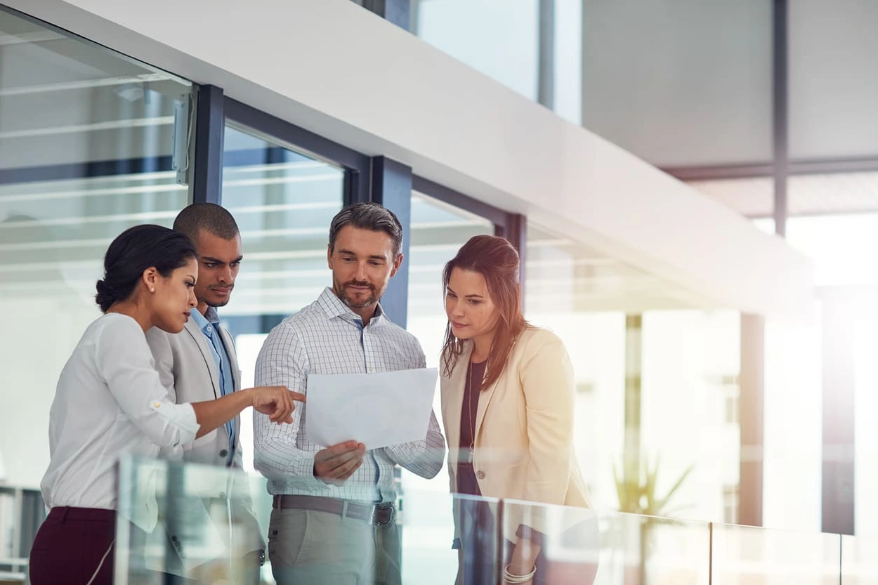 Coworkers assessing print quality and trying to find solutions