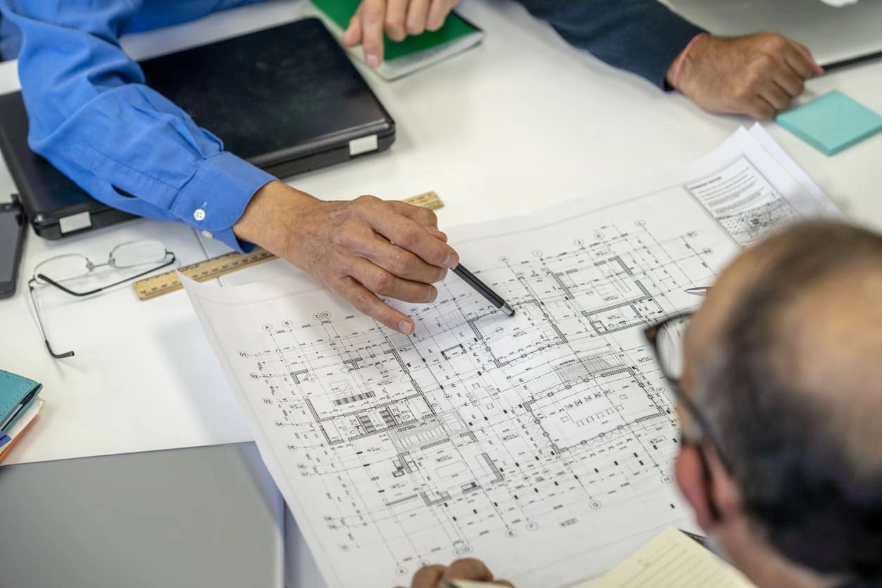 Co-workers inalizing multiple types of construction drawing details