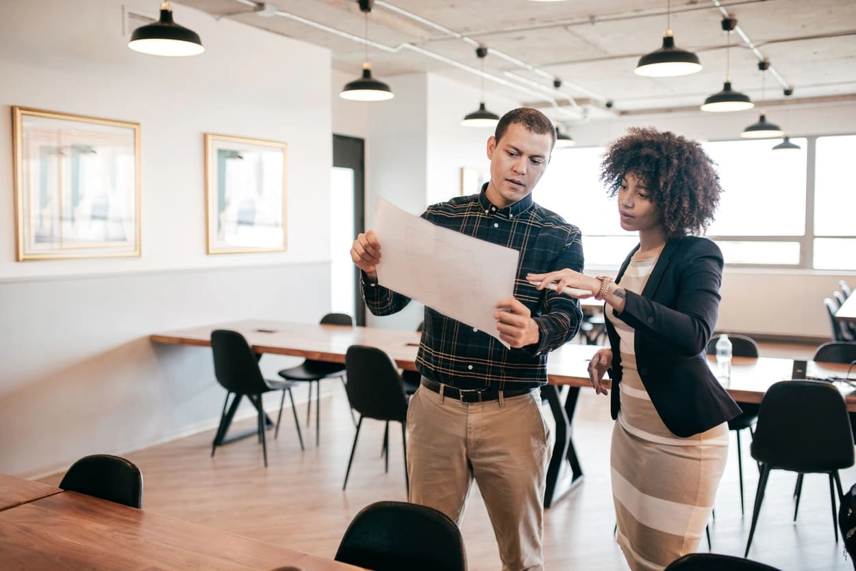 Designers considering revisions during a large format poster printing project