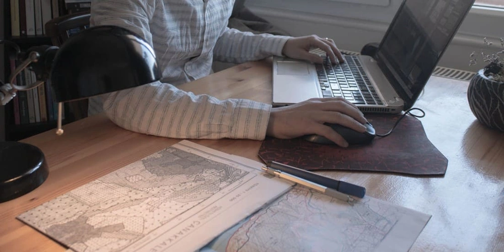 Professional refining a GIS topographic map in the office