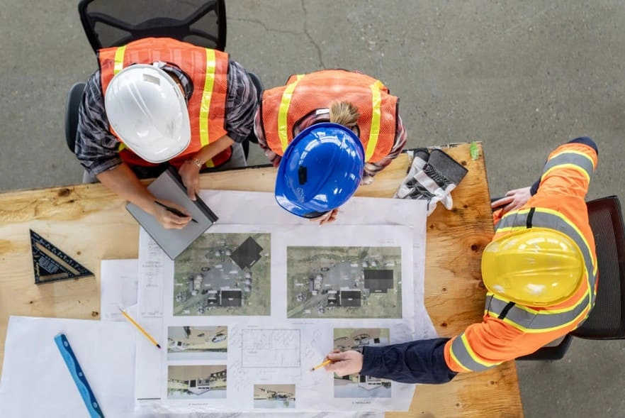 Construction team reviewing construction submittal prints