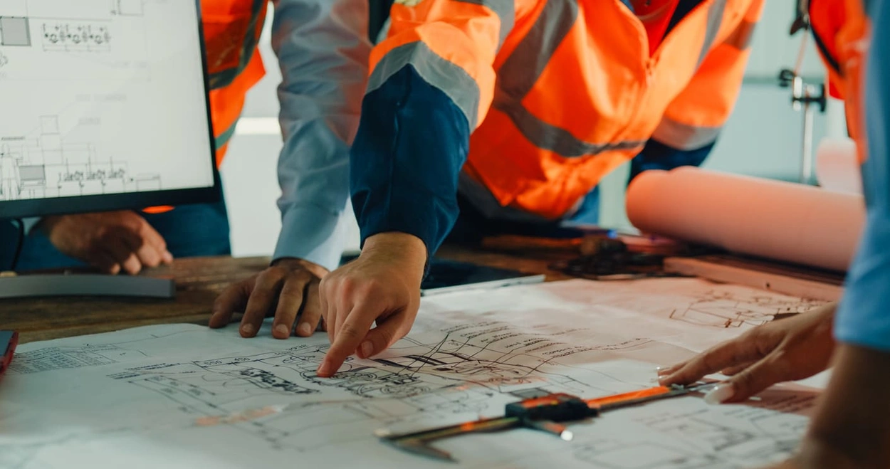 Construction team using online files and multiple types of large format printing in a meeting